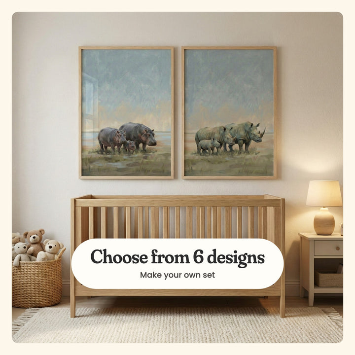 Cream nursery with two animal family prints in light wood frames above a light wood crib, beside a basket of teddy bears and a table lamp: Gentle River Giants and Grassland Rhino Family, labeled Choose from 6 designs, Make your own set