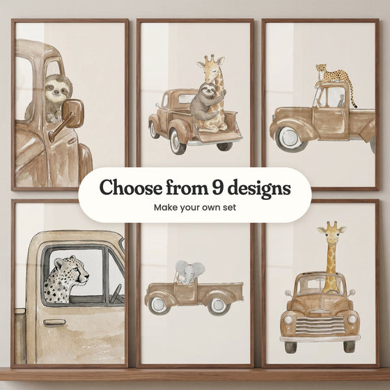 Six safari truck prints in walnut frames standing on a walnut shelf: a sloth peeking out a truck window, a sloth hugging a giraffe in a pickup, a cheetah lying on a truck roof, a cheetah looking out a window, an elephant driving a pickup and a giraffe at the wheel with its head through the roof, with a label reading Choose from 9 designs, Make your own set