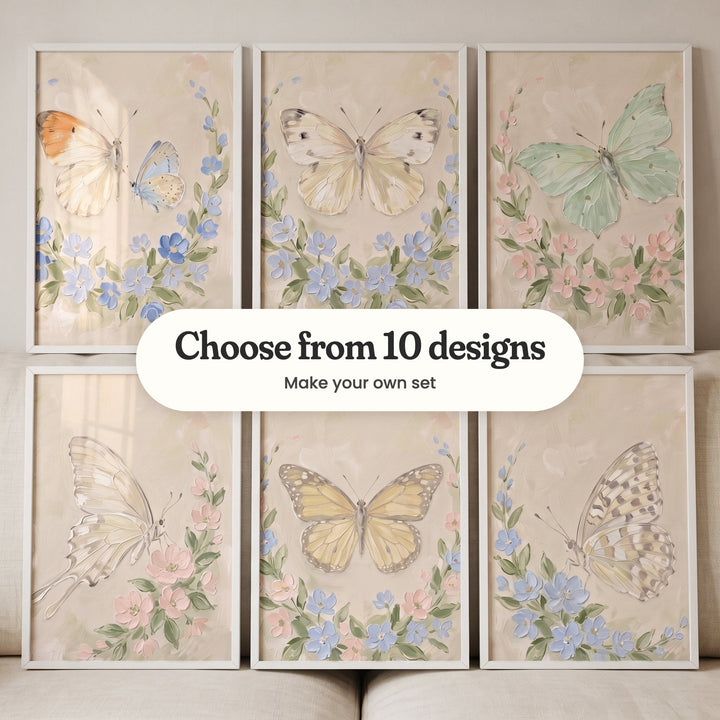 Six butterfly prints in white frames in two rows leaning on a cream sofa: an orange-tip and a small blue butterfly in a blue wreath, a cream white butterfly in a blue wreath, a mint green butterfly in a blush wreath, a cream swallowtail with blush blossoms, a soft yellow butterfly in a blush and blue wreath and a spotted butterfly with blue blossoms, with a label reading Choose from 10 designs, Make your own set