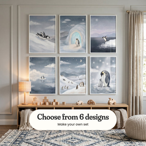 Grey panelled kids' room with six penguin prints in white frames in two rows above a light wood toy bench with a lamp, wooden blocks and toy cars, beside a knit pouf and baskets with throws: Midnight Snow Slide, Starlit Ice Cave, Penguin Ice Dive, Starlit Penguin Duo, Moonlit Penguin Play and Starry Arctic Night, with a label reading Choose from 6 designs, Make your own set