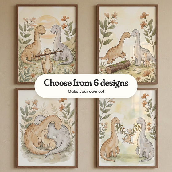 Four dinosaur family prints in walnut frames in two rows on a taupe wall: the baby carrying a stick past its smiling parents, a parent leaping over a mossy log, the parents curled around their baby and the baby swinging from a vine held by its parents, with a label reading Choose from 6 designs, Make your own set