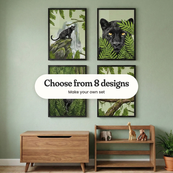 Sage green kids' room with four panther prints in black frames in two rows above a wood toy chest and a low wooden shelf with wooden toy elephant, giraffe and monkey figures, beside a potted fern: Jungle Mist Sentry, Shadow Feline Gaze, Shadowy Jungle Prowler and Midnight Jungle Leap, with a label reading Choose from 8 designs, Make your own set