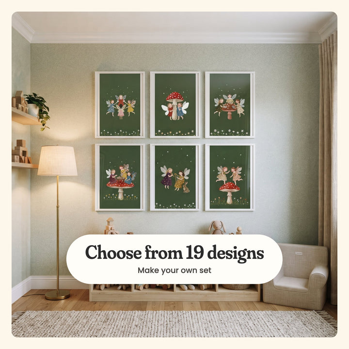 Playroom with six fairy prints in white frames in two rows on sage patterned wallpaper, above a wood cubby shelf with wooden toys and a plush bunny, beside a brass floor lamp and wall shelves with wooden houses: four fairies dancing in a ring, two behind a red mushroom, three baking cupcakes, three at tea on a mushroom, two playing a flute and a harp and two dancing on a mushroom, labeled Choose from 19 designs, Make your own set