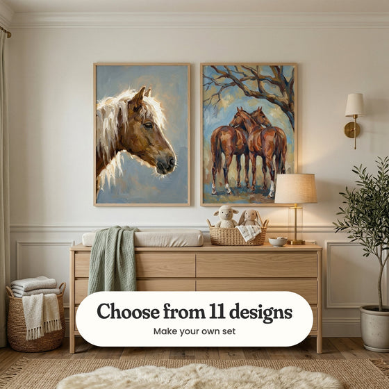 Cream panelled nursery with two horse prints in light wood frames above a light oak dresser with a changing pad and a sage green throw, beside a brass wall light, a basket of folded blankets and a potted olive tree: Wild White Mane and Gentle Equine Bond, with a label reading Choose from 11 designs, Make your own set