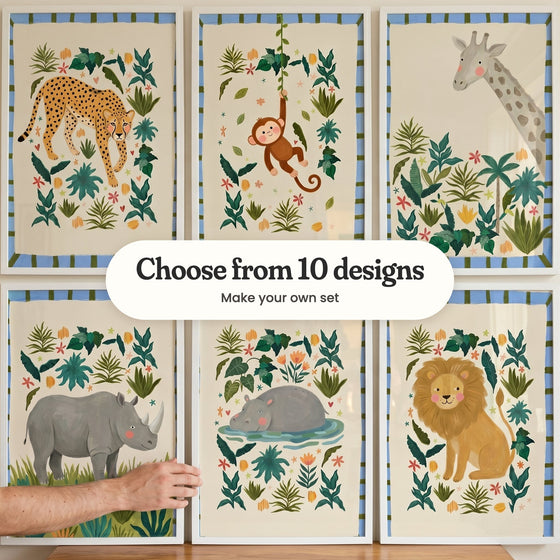 Six jungle animal prints with blue-and-green striped borders in white frames in two rows, with a hand holding the lower left frame: a cheetah among leaves, a monkey swinging on a vine, a giraffe above tropical plants, a grey rhino in grass, a hippo resting in a pond and a golden lion, with a label reading Choose from 10 designs, Make your own set