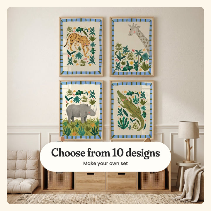 Kids' room with four jungle animal prints in light wood frames in two rows on a panelled wall, above a light wood cube shelf with cane baskets, beside a quilted floor cushion and a branch lamp on a stool: a cheetah among leaves, a giraffe above tropical plants, a grey rhino in grass and a crocodile among leaves, labeled Choose from 10 designs, Make your own set
