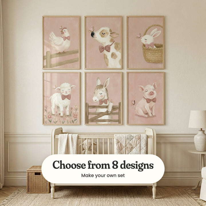 Cream panelled nursery with six farm animal prints in light wood frames in two rows above a white crib with a patchwork quilt and a plush lamb, beside a side table with a white lamp, a wicker box and a woven rug: Sweet Pink Hen, Dapper Pink Calf, Sweetest Basket Bunny, Gentle Little Lamb, Gentle Donkey Friend and Dapper Pink Piglet, with a label reading Choose from 8 designs, Make your own set