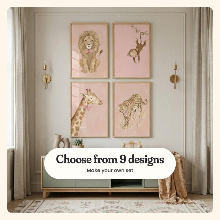 Nursery with four safari animal prints in light wood frames between brass sconces, above a low sage cabinet with ceramic vases, a wooden toy and a knit throw: a lion with a butterfly at its paw, a monkey swinging from a vine, a giraffe in a bow tie and a leopard in tall grass, labeled Choose from 9 designs, Make your own set