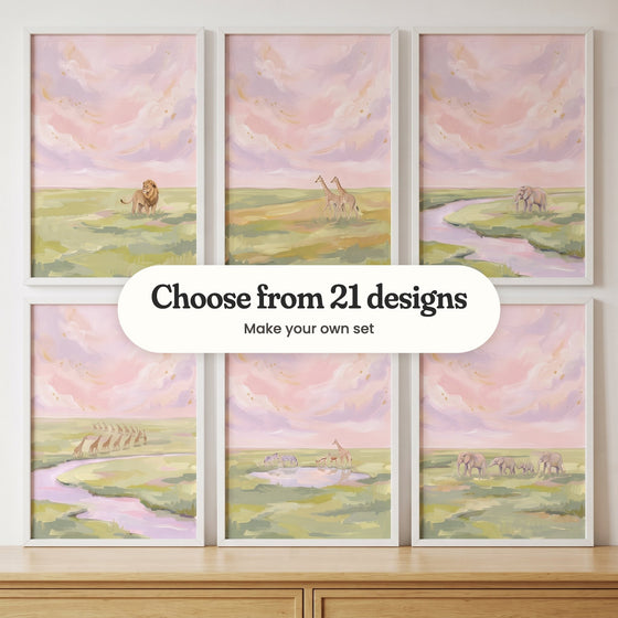 Six blush sky savanna prints in white frames in two rows above a light wood dresser: a lion standing in the grass, two giraffes, an elephant by a lilac river, a long line of giraffes by a river, zebras, antelope and a giraffe at a waterhole and an elephant family walking, with a label reading Choose from 21 designs, Make your own set