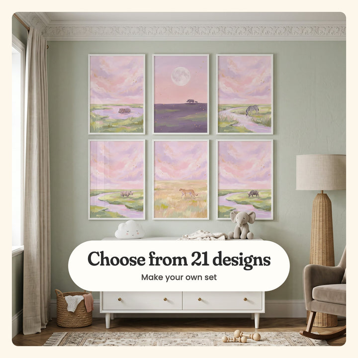 Nursery with six blush sky savanna prints in white frames in two rows on a sage green wall, above a white dresser with a cloud lamp and a plush elephant, beside a wicker floor lamp and a rocking armchair: a hippo in a pink pool, a rhino and calf under a full moon, a zebra drinking, a rhino by a river, a cheetah in golden grass and a buffalo by a river, labeled Choose from 21 designs, Make your own set