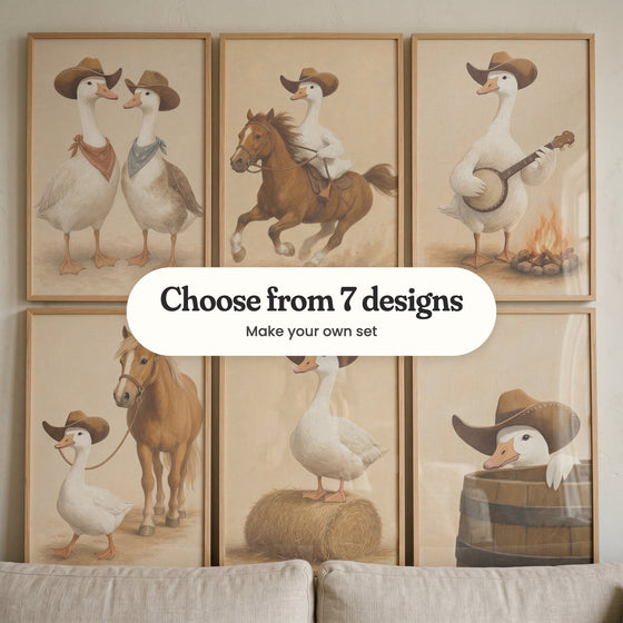 Six cowboy goose prints in light wood frames leaning above the back of a linen sofa: two geese in bandanas, a goose riding a chestnut horse, a goose with a banjo, a goose leading a pony, a goose on a hay bale and a goose peeking out of a barrel, with a label reading Choose from 7 designs, Make your own set