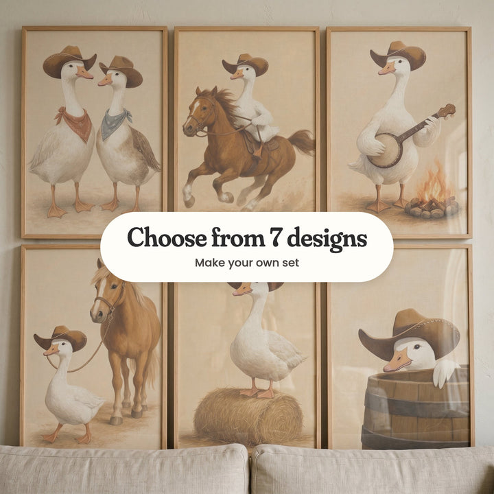 Six cowboy goose prints in light wood frames leaning above the back of a linen sofa: two geese in bandanas, a goose riding a chestnut horse, a goose with a banjo, a goose leading a pony, a goose on a hay bale and a goose peeking out of a barrel, with a label reading Choose from 7 designs, Make your own set