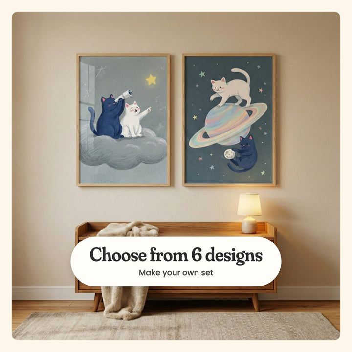 Beige nursery wall with two cat prints in light wood frames above a low wood bench with a cream throw and a table lamp: Celestial Cat Friends and Cosmic Cat Play, labeled Choose from 6 designs, Make your own set