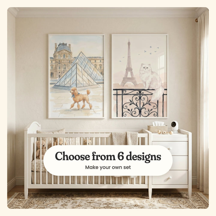 Cream nursery with two Paris prints in white frames above a white crib with plush bears and a knit blanket and a white changing dresser, on a patterned rug: Parisian Poodle Stroll and Parisian Balcony Cat, labeled Choose from 6 designs, Make your own set