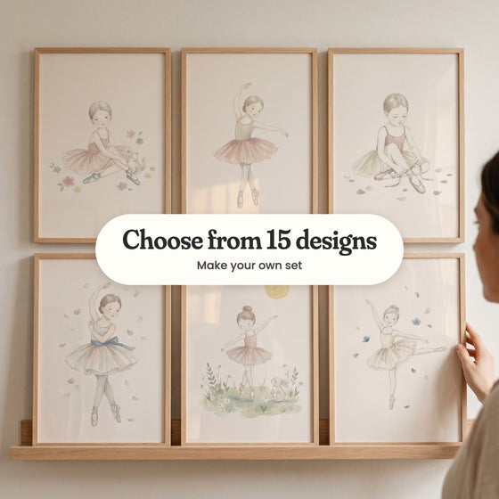 Six ballerina prints in light wood frames on a picture ledge, with a woman touching one: a ballerina sitting with a kitten, a ballerina on pointe with one arm raised, a ballerina tying her pointe shoe ribbons, a ballerina among falling petals, a ballerina dancing beside a bunny and a ballerina in a yellow tutu, with a label reading Choose from 15 designs, Make your own set
