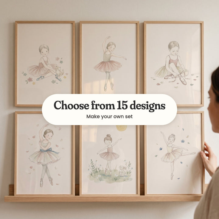 Six ballerina prints in light wood frames on a picture ledge, with a woman touching one: a ballerina sitting with a kitten, a ballerina on pointe with one arm raised, a ballerina tying her pointe shoe ribbons, a ballerina among falling petals, a ballerina dancing beside a bunny and a ballerina in a yellow tutu, with a label reading Choose from 15 designs, Make your own set