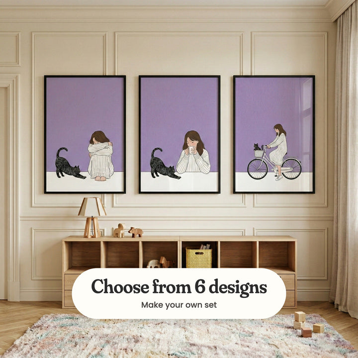 Cream panelled room with three girl and cat prints in black frames above a low light wood shelf with a small lamp and wooden toys, beside a linen curtain and a shaggy pastel rug: Quiet Company, Cozy Morning Sip and Lavender Cycle Companion, with a label reading Choose from 6 designs, Make your own set