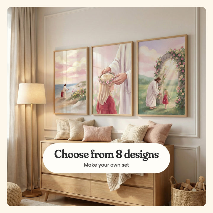 Cream panelled room with three prints in light wood frames above a light wood dresser with pink and cream pillows and a knit throw, beside a floor lamp, a pouf and a basket of wooden toys: Walking With Jesus, Jesus Crowns Her and Jesus Welcoming Child, labeled Choose from 8 designs, Make your own set