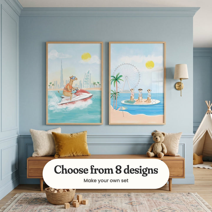 Blue panelled kids' room with two beach animal prints in light wood frames above a low wooden bench with cushions and a teddy bear, beside a play teepee and a basket of wooden blocks: Camel Sea Splash and Tropical Meerkat Trio, with a label reading Choose from 8 designs, Make your own set