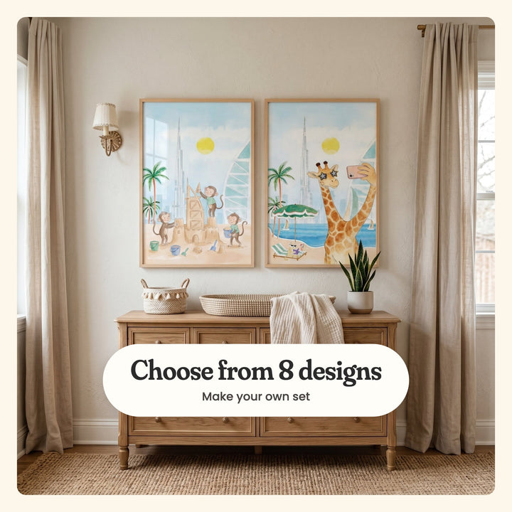 Nursery between linen curtains with two beach animal prints in light wood frames above a wooden dresser with woven baskets, a throw and a potted plant: Little Beach Builders and Stellar Giraffe Selfie, labeled Choose from 8 designs, Make your own set