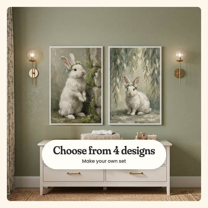 Sage wall with two white bunny prints in white frames between brass globe sconces, above a white dresser with folded blankets and a wooden toy train, beside a floral curtain on a jute rug: a bunny standing by a mossy stone wall and a bunny in a daisy crown under willow branches, labeled Choose from 4 designs, Make your own set