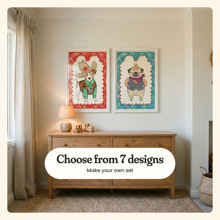 Cream nursery with two dog prints in white frames above a light wood dresser with a lamp and wooden toy cars, beside linen curtains and a woven basket: Little Rodeo Star and Cowboy Dreamer, labeled Choose from 7 designs, Make your own set