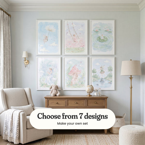 Pale blue nursery with six fairy prints in white frames in two rows above a wood dresser with a plush bunny and a globe, beside a cream armchair, a wall light and a floor lamp: Dandelion Dream Drift, Fairy Rose Swing, Serene Pond Fairy, Gossamer Web Harp, Whimsical Fairy Garden and Whimsical Forest Fairy, with a label reading Choose from 7 designs, Make your own set