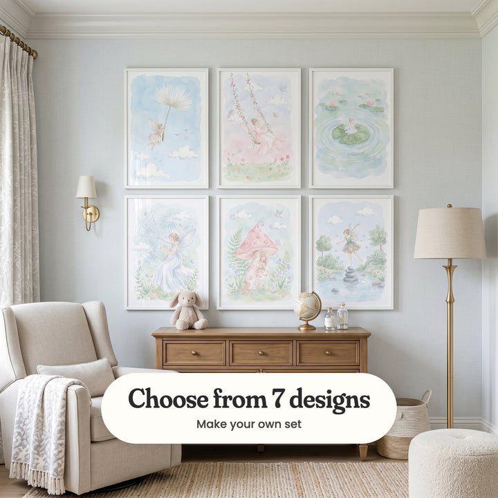 Pale blue nursery with six fairy prints in white frames in two rows above a wood dresser with a plush bunny and a globe, beside a cream armchair, a wall light and a floor lamp: Dandelion Dream Drift, Fairy Rose Swing, Serene Pond Fairy, Gossamer Web Harp, Whimsical Fairy Garden and Whimsical Forest Fairy, with a label reading Choose from 7 designs, Make your own set