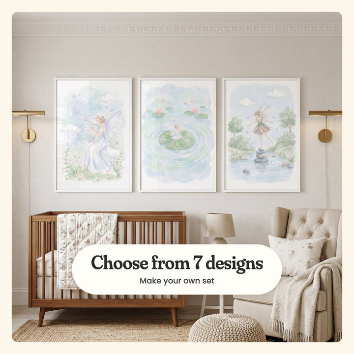 Cream nursery with three fairy prints in white frames between two brass wall lights, above a wood crib with a floral quilt, beside a tufted armchair and a table lamp: Gossamer Web Harp, Serene Pond Fairy and Whimsical Forest Fairy, labeled Choose from 7 designs, Make your own set