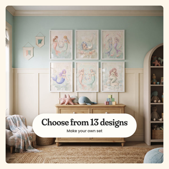 Playroom with six mermaid prints in white frames in two rows on a mint green wall over cream wainscot, above a wood dresser with a plush starfish, a plush whale and pastel blocks, beside pennant flags, an arched shelf of plush toys and a jute rug: two mermaids holding a wreath, a mermaid lying by seashells, two among pink fish, a lavender-haired mermaid, two by a wreath and one sitting on a rock, labeled Choose from 13 designs, Make your own set