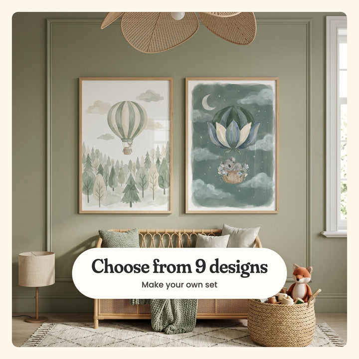 Sage green panelled room with two balloon prints in light wood frames above a rattan daybed with cushions and a knit throw, under a woven pendant light, beside a floor lamp and a basket with a plush fox: Whimsical Forest Flight and Dreamy Koala Drift, labeled Choose from 9 designs, Make your own set