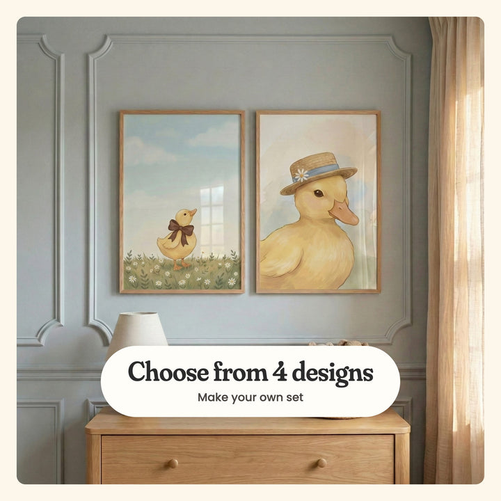 Blue grey panelled room with two duckling prints in light wood frames above a light wood dresser with a table lamp, beside a linen curtain: Sweet Ribbon Duck and Dapper Little Duckling, labeled Choose from 4 designs, Make your own set