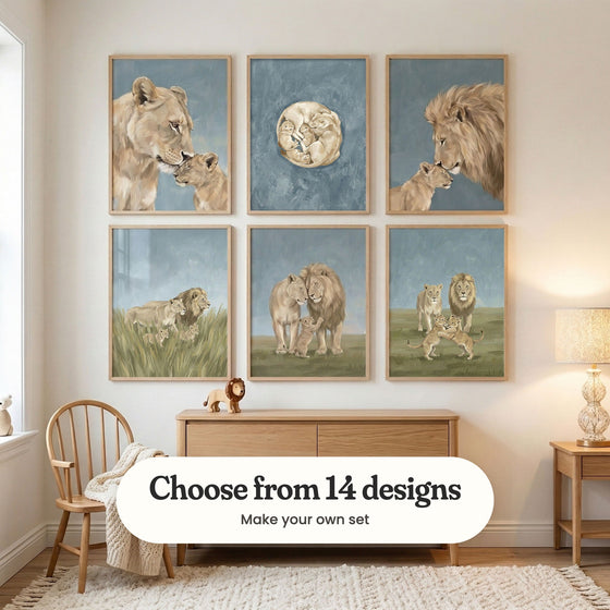 Nursery with six lion family prints in light wood frames in two rows above a light wood sideboard with a toy lion, beside a wooden chair and a table lamp: Maternal Wild Grace, Golden Pride Circle, Gentle Lion Bond, Lions in Tall Grass, Savanna Family Bond and Golden Savanna Pride, with a label reading Choose from 14 designs, Make your own set