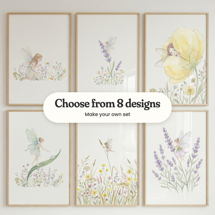 Six fairy prints in light wood frames in two rows on a pale wall: a fairy greeting a white duck, a fairy with rainbow wings on a lavender stem, a fairy peeking out of a yellow flower, a fairy walking up a long leaf, a tiny fairy holding a cattail above buttercups and a fairy in a lavender petal dress, with a label reading Choose from 8 designs, Make your own set