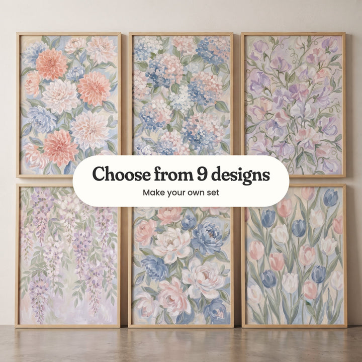 Six pastel flower prints in light wood frames leaning in two rows on a concrete floor against a pale wall: coral and blue dahlias, blue and pink hydrangeas, lavender sweet peas, lavender wisteria, blush and blue peonies and pink and blue tulips, with a label reading Choose from 9 designs, Make your own set