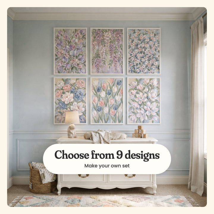 Nursery with a pale blue wall and six pastel flower prints in white frames in two rows above a white dresser with a ceramic bunny lamp, a changing pad and wooden blocks, beside a woven basket on a pastel rug: lavender sweet peas, lavender wisteria, pale pink cherry blossoms, blush and blue peonies, pink and blue tulips and blush white magnolias, labeled Choose from 9 designs, Make your own set