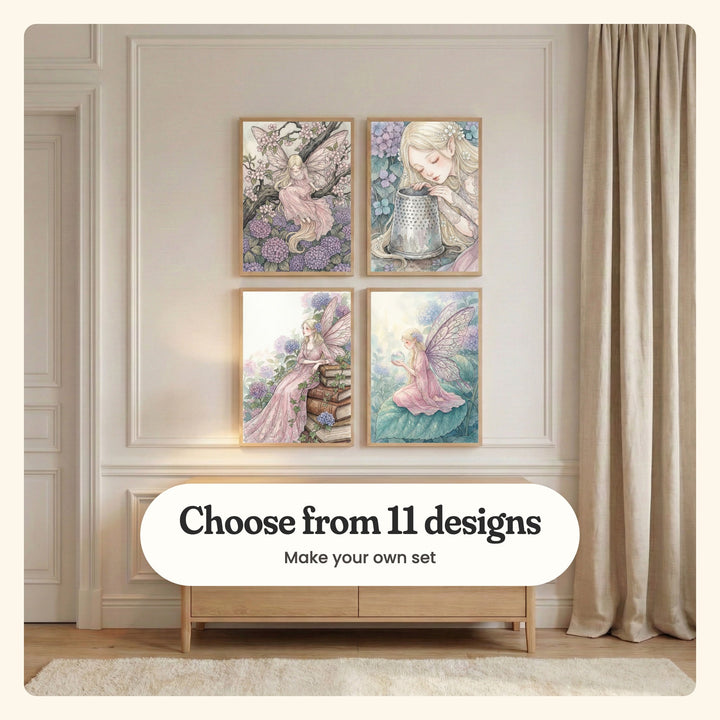 White panelled wall with four fairy prints in light wood frames in two rows above a low light wood cabinet, beside linen curtains: Blossom Branch Fairy, Enchanted Thimble Rest, Enchanted Bookland Muse and Mystic Garden Fairy, labeled Choose from 11 designs, Make your own set