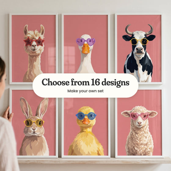 Six farm animal portraits in white frames on a picture ledge, with a woman reaching up: a llama in star glasses, a duck in heart glasses, a cow in yellow glasses, a bunny in round glasses, a duckling in blue glasses and a lamb in heart glasses, with a label reading Choose from 16 designs, Make your own set