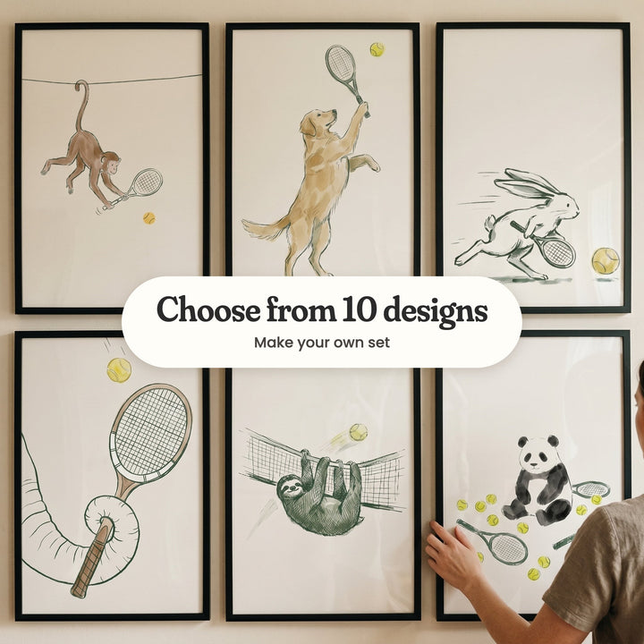 Six tennis animal prints in black frames in two rows on a beige wall: a monkey swinging by its tail, a golden retriever reaching with a racket, a hare running for a ball, an elephant's trunk holding a racket, a sloth hanging from a net and a panda among balls and rackets, with a label reading Choose from 10 designs, Make your own set