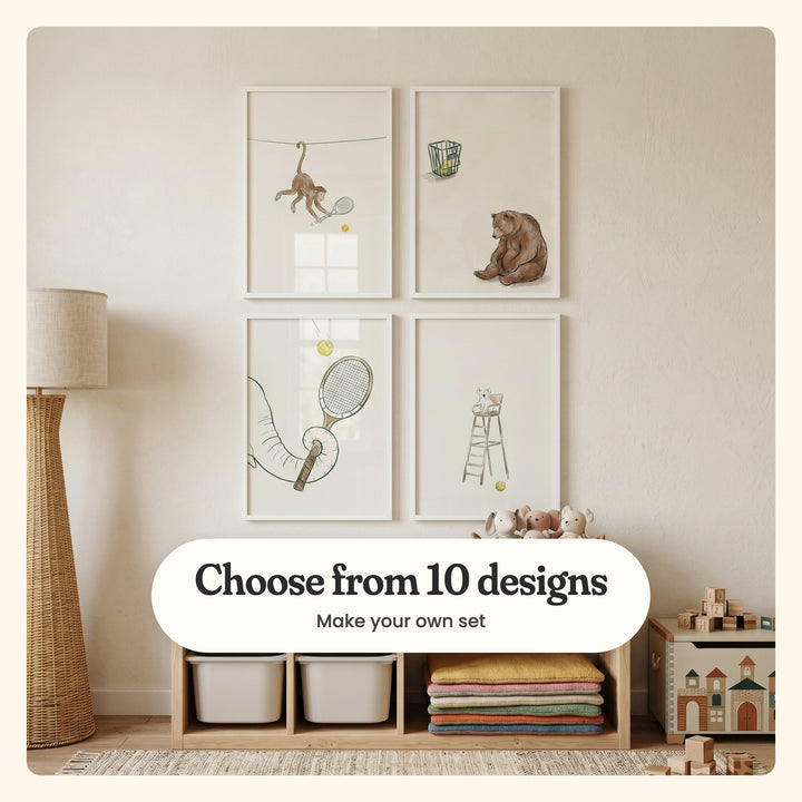Nursery with four tennis animal prints in white frames in two rows on a cream wall above a light wood cube shelf with white bins, plush bunnies and stacked blankets: a monkey swinging at a ball, a bear below a basket of balls, an elephant's trunk holding a racket and a koala umpire, labeled Choose from 10 designs, Make your own set