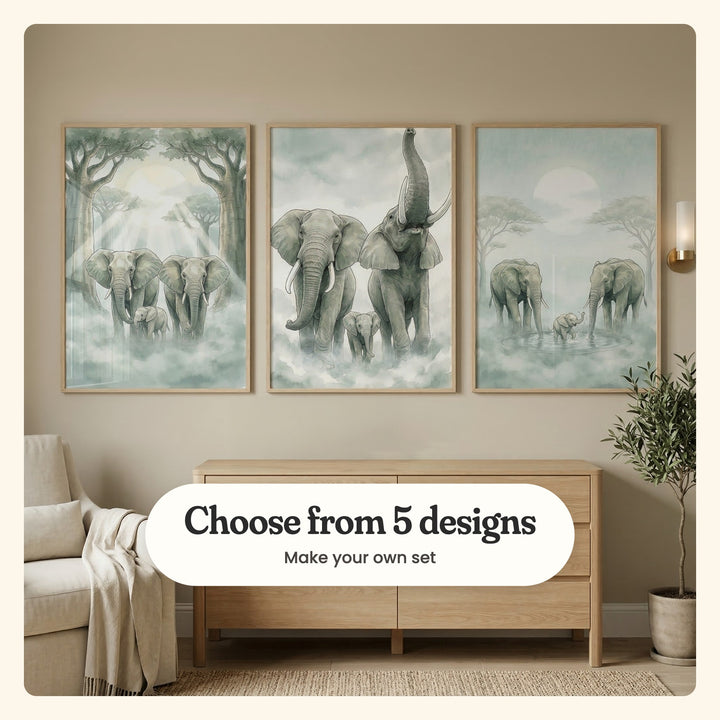 Three elephant family prints in light wood frames above an oak dresser, beside an armchair and a potted olive tree: elephants between tall trees, a family with one trumpeting and a calf splashing in a waterhole, labeled Choose from 5 designs, Make your own set