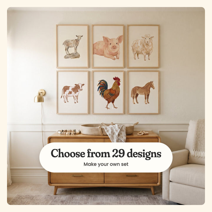 Nursery with six farm animal prints in light wood frames in two rows beside a brass wall lamp, above a wood dresser with a woven changing basket and a muslin blanket, beside a cream glider: a goat on a rock, a smiling piglet, a woolly sheep, a brown and white cow, a rooster and a chestnut horse, labeled Choose from 29 designs, Make your own set