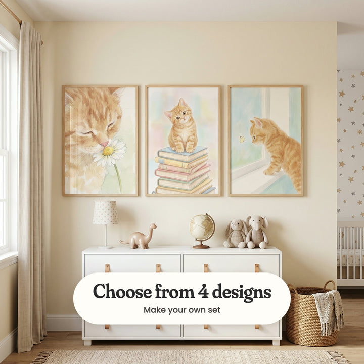 Cream nursery with three ginger kitten prints in light wood frames above a white dresser with a lamp, a globe, a toy dinosaur and plush toys, beside a woven basket: Sweet Floral Whiskers, The Bookish Tabby and Curious Ginger Kitten, with a label reading Choose from 4 designs, Make your own set