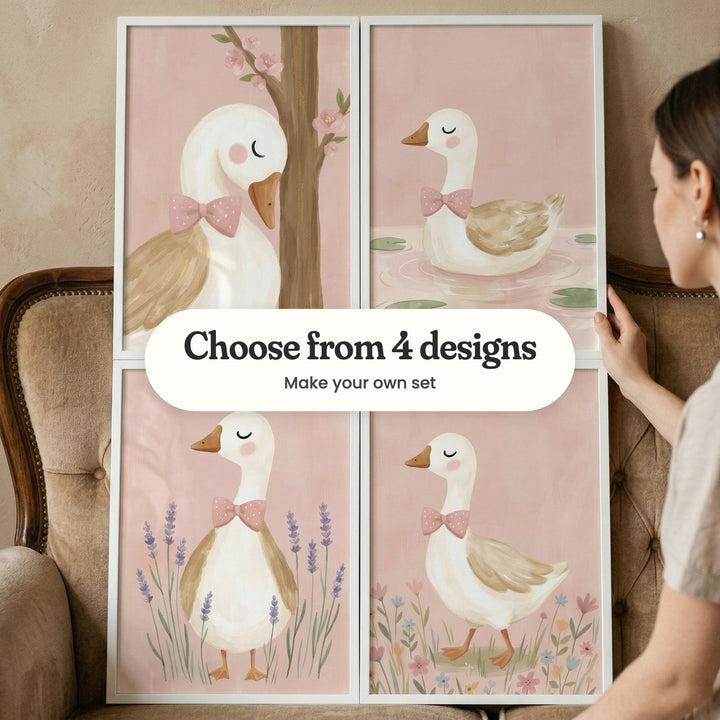 Four goose prints in white frames held up against the back of a tan tufted sofa by a woman, each goose wearing a pink polka-dot bow, with a label reading Choose from 4 designs, Make your own set