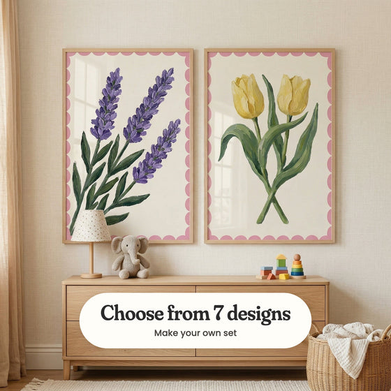 Cream room with two flower prints in light wood frames above a light wood dresser with a small lamp, a plush elephant and stacking toys, beside a woven basket: Lavender Sprig Trio and Double Tulip Charm, with a label reading Choose from 7 designs, Make your own set