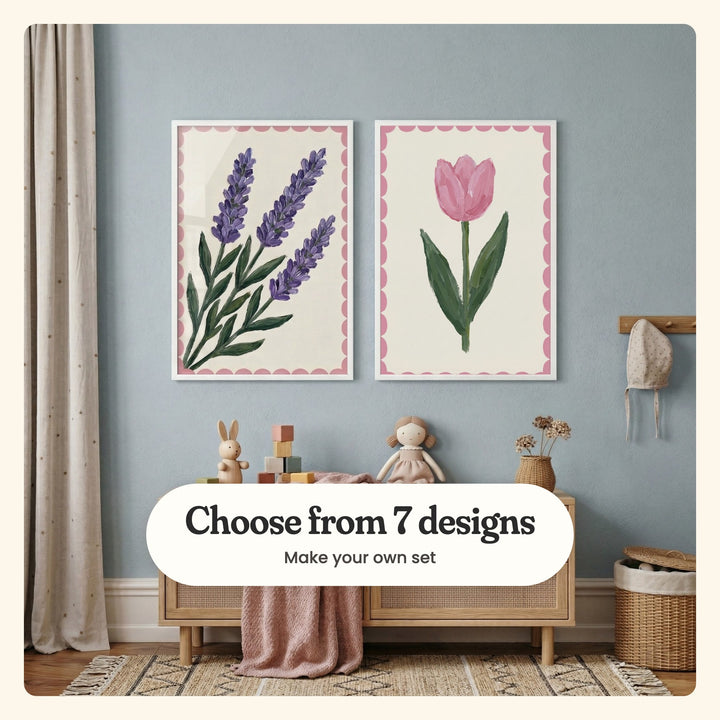 Powder blue nursery with two flower prints in white frames above a rattan cabinet with a toy bunny, wooden blocks and a doll, beside a curtain, a woven basket and a patterned rug: Lavender Sprig Trio and Blushing Spring Bloom, labeled Choose from 7 designs, Make your own set