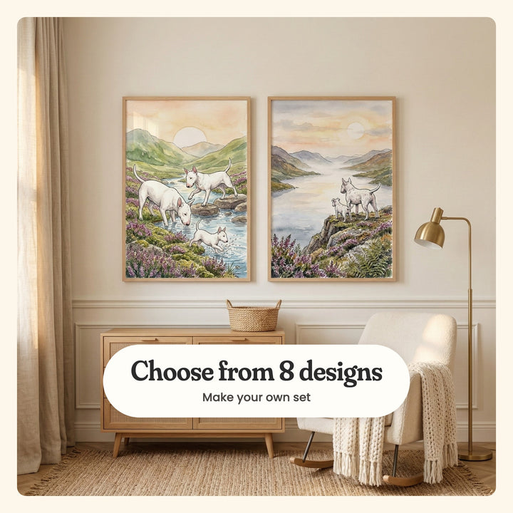 Cream nursery with two bull terrier prints in light wood frames above a cane front dresser with a woven basket, beside a cream rocking chair with a knit throw and a brass floor lamp: Highland Stream Hounds and Golden Hour Lookout, labeled Choose from 8 designs, Make your own set