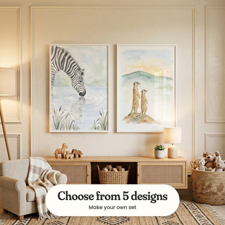 Cream panelled room with two wild animal prints in white frames above a light wood rattan sideboard with wooden toy animals, a table lamp, a small plant and a basket with a plush monkey, a teddy bear and a knit bunny, beside a cream armchair with a striped throw and a floor lamp: Striped Mirror Reflection and Sunset Meerkat Pair, with a label reading Choose from 5 designs, Make your own set