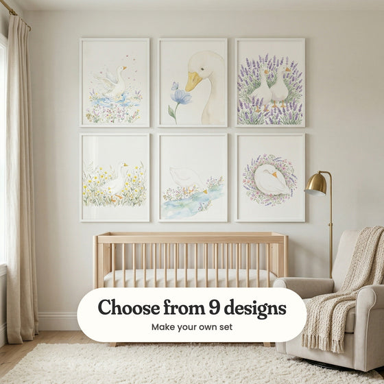 Nursery with six goose prints in white frames in two rows above a light wood crib, beside a brass floor lamp and a cream armchair with a knit throw: Whimsical Meadow Splash, Gentle Garden Friend, Lavender Field Geese, Golden Meadow Goose, Serene Meadow Goose and Sleeping Floral Goose, with a label reading Choose from 9 designs, Make your own set