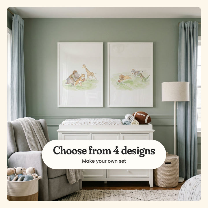 Sage nursery wall with two safari animal football prints in white frames above a white changing dresser with a plush football, beside a grey glider and blue curtains: a hippo and a tiger charging with the ball past a giraffe, and a lion diving over the line chased by a zebra and a crocodile, labeled Choose from 4 designs, Make your own set